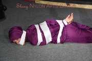 Sexy Sandra being tied, gagged and hooded with tape on the floor wearing a supersexy purple rain overall (Pics)