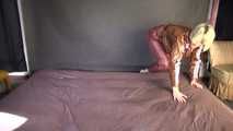 Watching sexy Sonja wearing a brown shiny nylon rainwear combination while preparing her bed (Video)