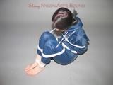 Beautiful slim archive girl tied and gagged in a swhiny blue rainwear on the floor (Pics)