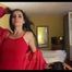 Miss Amira in a red minidress and red nylon raincoat having fun in a hotel room