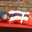 Mara tied, gagged and hooded on bed wearing a shiny red/blue/white striped old school down jacket and a skibib in red (Pics)