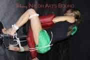 Watching sexy Sandra wearing a sexy green shiny nylon shorts and a black top being tied and gagged with ropes and a clothgag on a chair (Pics)