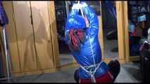 Sonja tied with ropes overhead and gagged with a clothgag wearing sexy black leather pants with a red shiny nylon shorts over it and a special blue down jacket (Video)