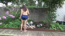 Watching Ayiana wearing  only a sexy blue shiny nylon shorts watering the flowers (Video)