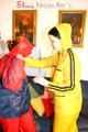 Jill and a friend of her pplaying with eachother wearing yellow and red shiny nylon rainwear (Pics)