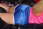 Watching sexy ARCHIVE GIRL wearing a sexy blue shiny nylon shorts and a pink rain jacket posing and lolling on bed for you (Pics)