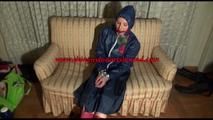 Mara tied, gagged and hooded on an old sofa wearing a cool blue rain skirt and a jacket as well as rubber boots (Video)