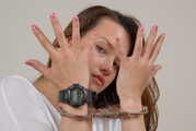 Alice wearing a black G-Shock and handcuffs 