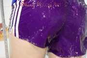 Sonja taking a shower wearing a very hot purple shiny nylon shorts and a blue rain jacket (Pics)