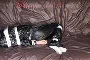 Sexy Courtney being tied and gagged with tape on a bed wearing black rainwear (Pics)