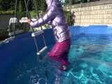 Watch Sandra enjoying her shiny nylon Downwear at a warm Summer Day in the Garden and in the Pool