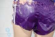 Sonja taking a shower wearing a very hot purple shiny nylon shorts and a blue rain jacket (Pics)