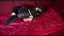 Lucy tied and gagged on a sofa wearing a sexy black rainwear combination (Video) 