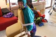 Mara tied and gagged and hooded on a chair wearing sexy shiny nylon shorts over a rainpants and a rain jacket (Pics)