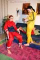Jill tied by her friend in shiny yellow and red rainsuits