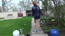 Watching our new modell RONJA wearing a sexy darkblue shiny nylon shorts and a darkblue rainjacket walking through a garden lolling in a hammock enjoying the cloth she wear (Video)