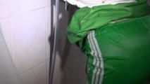 Sonja tied and gagged in a shower with tape and rope wearing a supersexy green shiny nylon shorts and rain jacket (Video)