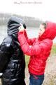 Beautiful archive girl tied and gagged outdoor by another one both wearing a shiny downjacket (Pics)