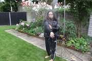 Watching Aiyana wearing a sexy black shiny nylon rainpant and a black shiny nylon down jacket trying the garden shower  (Pics)