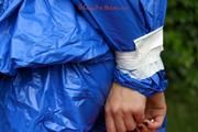 Nicole in an blue sauna suit tied and gagged in the garden (Pics)