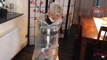 Miss Francine is bound and gagged in a nice short PVC dress covered with a transparent raincoat