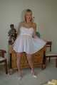 Busty blonde Marlen posing in a white negligee in the bedroom