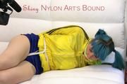 Mara tied and gagged on a white sofa wearing a sexy blue/yellow shorts and a yellow rain jacket (Pics)