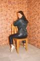 Sexy archive girl posing on a chair wearing supersexy shiny nylon rainwear (Pics)