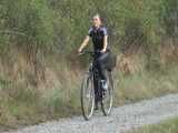 Watch Sandra riding her bike enjoying her shiny nylon Jumpsuit