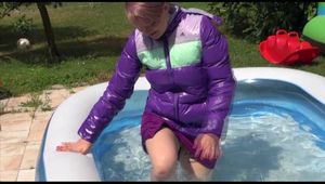 Watching Mara wearing a sexy short down skirt and a down jacket playing with water in the swimming pool (Video)