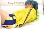 Mara tied and gagged on a white sofa wearing a sexy blue/yellow shorts and a yellow rain jacket (Pics)