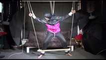 Mara tied, gagged and hooded overhead with ropes and a clothgag wearing a sexy rainwear combination (Video)