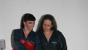 Jill and Petra touching eachother while wearing shiny nylon rainwear (Pics)