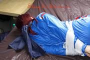 Mara tied and gagged on bed wearing s shiny blue PVC sauna suit (Pics)