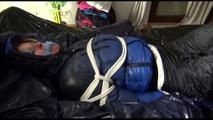 Pia tied, gagged and hooded lying on a bed with shiny nylon cloth wearing a sexy black adidas nylon pants and a blue down jacket(Video)