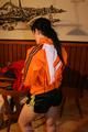 Jill wearing a sexy black nylon shorts and a orange rain jacket while dressing her up (Pics)