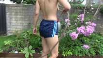 Watching Ayiana wearing  only a sexy blue shiny nylon shorts watering the flowers (Video)