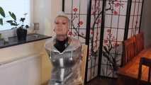 Miss Francine is bound and gagged in a nice short PVC dress covered with a transparent raincoat