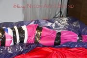 Lulu tied and gagged and hooded with tape on bed wearing a supersexy pink rainwear combination (Pics)