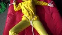 Watching sexy Pia being tied and gagged with ropes on a bed and a clothgag wearing sexy yellow shiny nylon rainwear (Video)