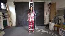 Ayana in a shiny nylon red rainsuit and a see through PVC Rainjacket, tied gagged, hooded and vibed