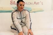 Jill posing and lolling on a sofa wearing supersexy white shiny nylon rainpants and rain jacket with hood (Pics)