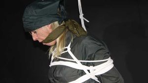 Sexy Pia wearing a special green rainwear combintaion with a special hood being tied and gagged with ropes and a clothgag overhead (Pics)