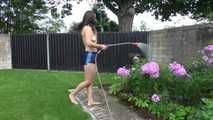 Watching Ayiana wearing  only a sexy blue shiny nylon shorts watering the flowers (Video)