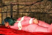 Mara tied and gagged on a princess bed in an old cellar wearing supersexy shiny pink downwear (Pics)