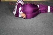 Sexy Sandra being tied, gagged and hooded with tape on the floor wearing a supersexy purple rain overall (Pics)