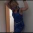 Pia tied and gagged on the stairway over her head wearing a supersexy shiny blue bib overall (Video) 