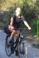 Watch Sandra riding her bike enjoying her red shiny nylon Shorts