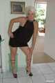 Blonde mature Claudia stipping out of a black dress