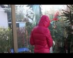 Mara wearing a black rain pants and a pink down jacket decorating the christmas tree (Video)